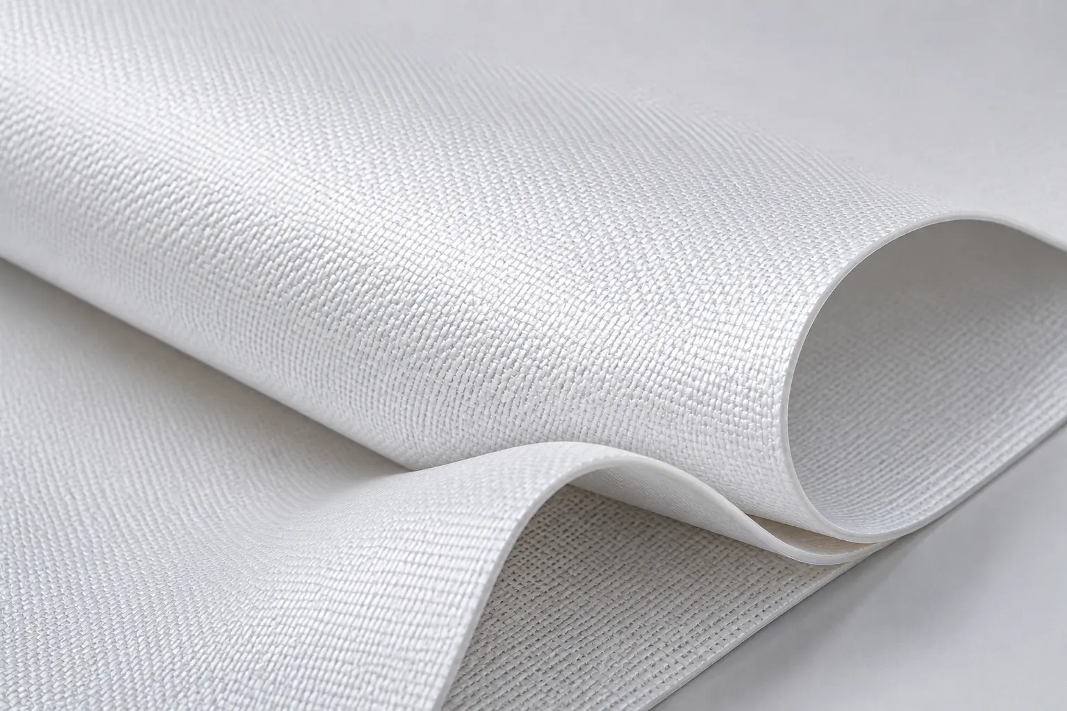 Close-up of PTFE-coated glass-fibre membrane: a matte white surface with the woven glass base visible through the fluoropolymer coating