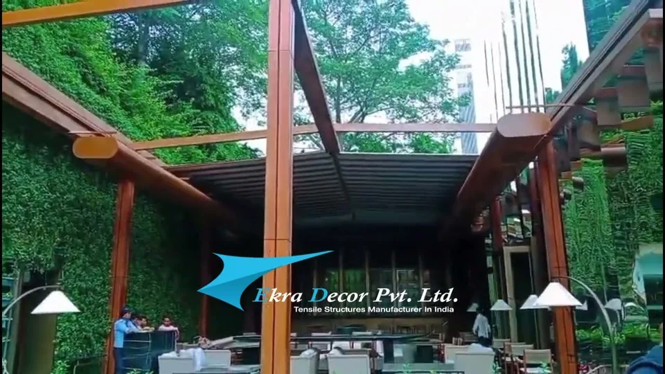 Motorised retractable fabric roof over a restaurant courtyard with planted walls